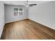This bedroom boasts wood-look flooring, a ceiling fan, and a sun-filled window at 1950 S Inlet, Marietta, GA 30066
