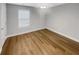 This bedroom features wood-look flooring, a ceiling fan, and bright natural light at 1950 S Inlet, Marietta, GA 30066