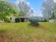 Traditional-style home with a large front lawn and mature trees on a sunny day at 1950 S Inlet, Marietta, GA 30066