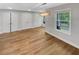 This living room offers wood-look floors, natural light, and a modern chandelier at 1950 S Inlet, Marietta, GA 30066