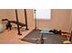 A well-lit basement featuring exercise equipment and rubber flooring at 2268 Redfern Rd, Dacula, GA 30019
