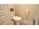 Cozy half bathroom featuring a toilet and a basket for storage at 2268 Redfern Rd, Dacula, GA 30019