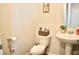 Cozy bathroom with pedestal sink, round mirror, toilet, and stylish decor at 2268 Redfern Rd, Dacula, GA 30019