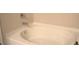 Bright, clean bathtub showing the faucet and clean tiling at 2268 Redfern Rd, Dacula, GA 30019