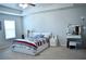 Neutral-toned primary bedroom featuring modern ceiling fan, carpeted floor, and accent lighting at 2268 Redfern Rd, Dacula, GA 30019