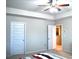 Bright primary bedroom with tray ceiling, ceiling fan, and neutral carpet, adjoins a separate room at 2268 Redfern Rd, Dacula, GA 30019