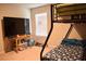 Well-lit bedroom with a bunk bed, a carpeted floor, and a table at 2268 Redfern Rd, Dacula, GA 30019