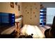 Well-lit bedroom decorated with a gaming theme, complete with shelves at 2268 Redfern Rd, Dacula, GA 30019