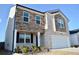 Charming two-story home with stone and brick exterior, a manicured lawn, and a two-car garage at 2268 Redfern Rd, Dacula, GA 30019