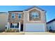Charming two-story home with stone and brick exterior, a manicured lawn, and a two-car garage at 2268 Redfern Rd, Dacula, GA 30019