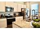 Bright kitchen featuring granite countertops, stainless steel appliances, and modern backsplash at 2268 Redfern Rd, Dacula, GA 30019
