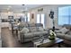 Open-concept living room featuring stylish furniture and views of the modern kitchen at 2268 Redfern Rd, Dacula, GA 30019