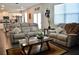 Bright living room with a stylish couch, wood floors, and natural light at 2268 Redfern Rd, Dacula, GA 30019