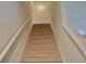 Carpeted stairway leading to the upper level of the house, with a white door visible at the top at 2268 Redfern Rd, Dacula, GA 30019