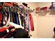 Walk-in closet with wire shelving holding clothing, storage containers, and other personal items at 2268 Redfern Rd, Dacula, GA 30019