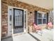 Inviting front porch with stone accents, features a stylish front door, sidelight, and two chairs at 3158 Arbor Oaks Way, Snellville, GA 30039