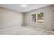 Neutral bedroom featuring a large window and carpet at 3540 Honeycomb Se Dr, Conyers, GA 30094
