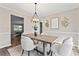 Bright dining room featuring an ornate light fixture and seating for four at 3540 Honeycomb Se Dr, Conyers, GA 30094