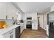 Modern kitchen featuring white cabinets, quartz countertops, stainless steel appliances, and stylish backsplash at 3540 Honeycomb Se Dr, Conyers, GA 30094