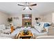 Comfortable living room with a brick fireplace, ceiling fan, and updated flooring at 3540 Honeycomb Se Dr, Conyers, GA 30094