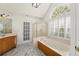 Bright bathroom with a tub and shower and beautiful marble floors at 1245 Village Terrace Ct, Dunwoody, GA 30338