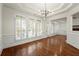 Bright dining room with hardwood floors, wainscoting, and large windows at 1245 Village Terrace Ct, Dunwoody, GA 30338