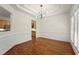 Elegant dining room featuring hardwood floors, stylish lighting, and wainscoting at 1245 Village Terrace Ct, Dunwoody, GA 30338