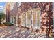 Elegant brick exterior featuring large windows with white trim and a spacious brick patio at 1245 Village Terrace Ct, Dunwoody, GA 30338