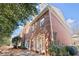 Charming brick home with large windows and classic architectural details, surrounded by mature trees at 1245 Village Terrace Ct, Dunwoody, GA 30338