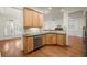 Open kitchen with wooden cabinets, stainless steel dishwasher, and granite countertops at 1245 Village Terrace Ct, Dunwoody, GA 30338