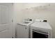 Laundry room with washer, dryer, and wire shelving at 1245 Village Terrace Ct, Dunwoody, GA 30338