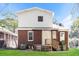 Backyard with a brick home, white siding, and a wooden porch with stairs at 1709 Rogers Sw Ave, Atlanta, GA 30310