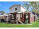 View of the backyard with covered porch, brick, and white siding on a sunny day at 1709 Rogers Sw Ave, Atlanta, GA 30310