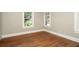 Bright bedroom with hardwood floors and neutral walls, featuring ample natural light from multiple windows at 1709 Rogers Sw Ave, Atlanta, GA 30310