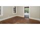 Cozy bedroom with hardwood floors and neutral walls, featuring large windows with natural light at 1709 Rogers Sw Ave, Atlanta, GA 30310
