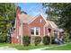 Side view of red brick home with chimney, trimmed bushes, and well-maintained lawn on a sunny day at 1709 Rogers Sw Ave, Atlanta, GA 30310