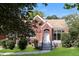 Charming brick home with landscaped front yard and inviting entryway under a clear blue sky at 1709 Rogers Sw Ave, Atlanta, GA 30310