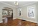 Bright living room with hardwood floors, classic chandelier, and arched doorway leading to another living area at 1709 Rogers Sw Ave, Atlanta, GA 30310