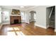 Spacious living room featuring hardwood floors, a cozy fireplace, and an open archway with natural light at 1709 Rogers Sw Ave, Atlanta, GA 30310