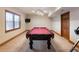Basement with a pool table, a window with blinds, and a unique chandelier, perfect for entertaining at 1755 Presidents Dr, Lawrenceville, GA 30043