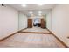 Mirrored basement space with tan carpeting, wood trim, and an open doorway to an adjacent seating area at 1755 Presidents Dr, Lawrenceville, GA 30043