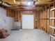 Unfinished basement with exposed wood framing, concrete floor and white double doors at 1755 Presidents Dr, Lawrenceville, GA 30043