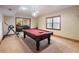 Basement with a pool table, a window with blinds, and a unique chandelier, perfect for entertaining at 1755 Presidents Dr, Lawrenceville, GA 30043