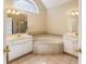 Bathroom with a soaking tub and double vanity sinks at 1755 Presidents Dr, Lawrenceville, GA 30043