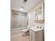 Bathroom featuring a shower-tub combination, a mirror above the sink, and a white vanity at 1755 Presidents Dr, Lawrenceville, GA 30043