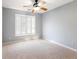 Bedroom with plush carpet and large window with shutters creates a serene space at 1755 Presidents Dr, Lawrenceville, GA 30043