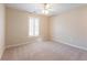 The room has a ceiling fan, a large window with blinds for natural light, and plush carpeting at 1755 Presidents Dr, Lawrenceville, GA 30043