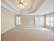 Spacious bedroom with tray ceiling, carpet, and plantation shutters at 1755 Presidents Dr, Lawrenceville, GA 30043