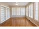 Light-filled bonus room with hardwood floors, plantation shutters, and custom built-in bookcases at 1755 Presidents Dr, Lawrenceville, GA 30043