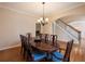 Dining room with hardwood floors, elegant table, and views of the fireplace and staircase at 1755 Presidents Dr, Lawrenceville, GA 30043